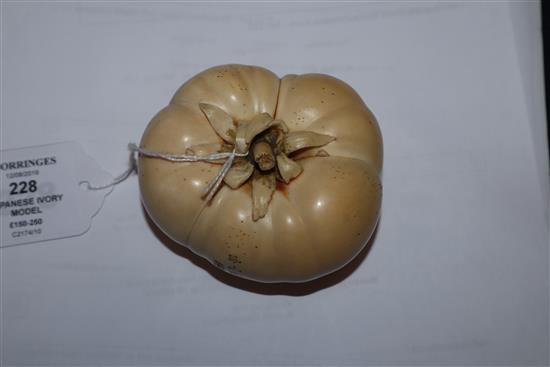 A good Japanese ivory model of a persimmon fruit, early 20th century, three character signature and seal, remnants of colouring to base